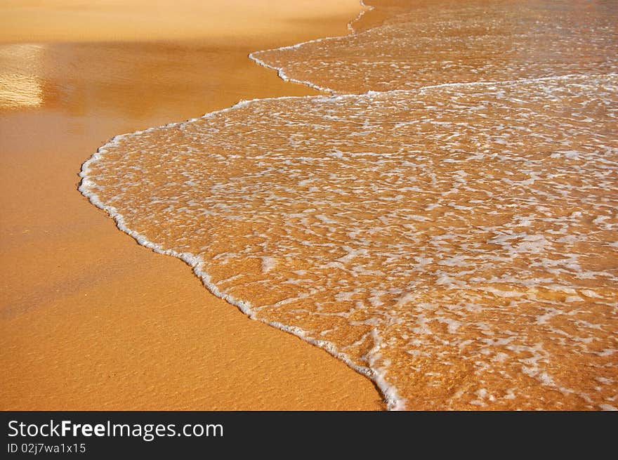 Background of wave on sand of the tropical beach