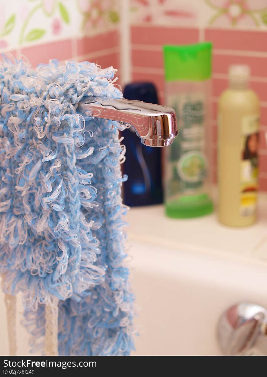 Bathroom. The crane on the background of shampoos.