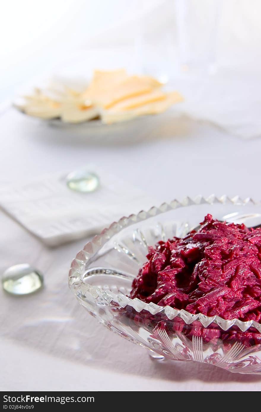 Salad from red beet on glass plate