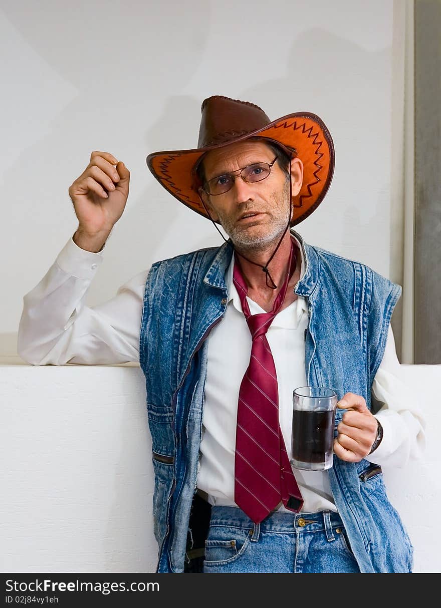 Old Man in glasses and cowboy hat with mug