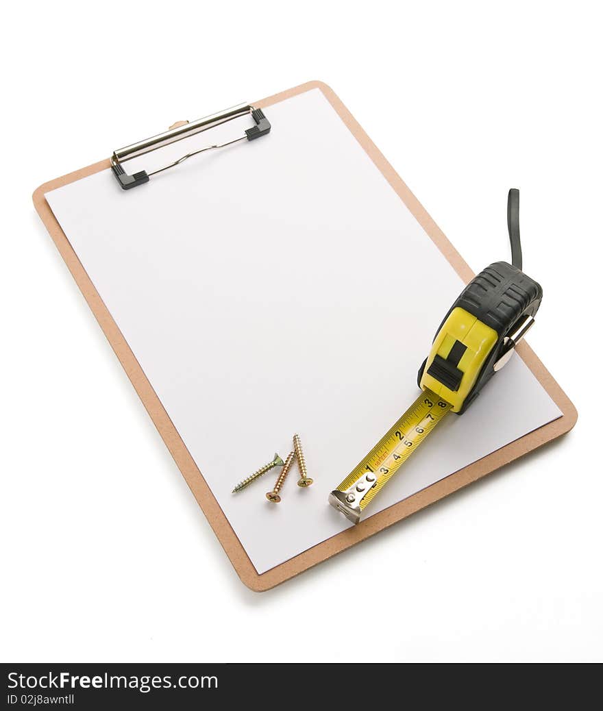 Tape measure and screws laying on blank clipboard. Tape measure and screws laying on blank clipboard.