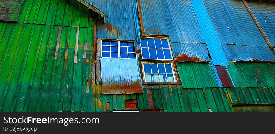 The colorful side an old tin building used for industrial parts storage in Aurora Oregon. The colorful side an old tin building used for industrial parts storage in Aurora Oregon