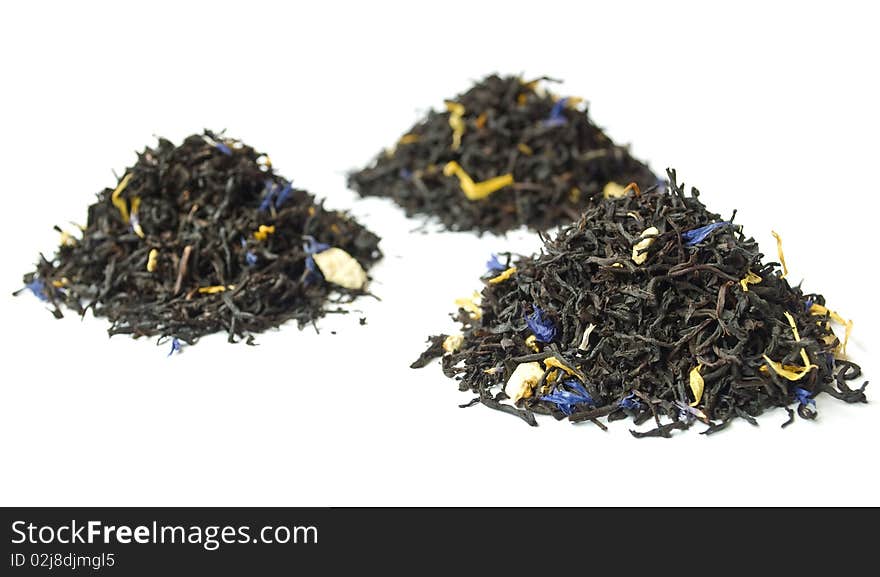 Piles of black tea isolated on white