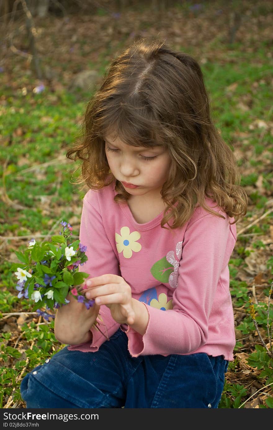 Little upset girl with bouquet of snowdrops. Little upset girl with bouquet of snowdrops