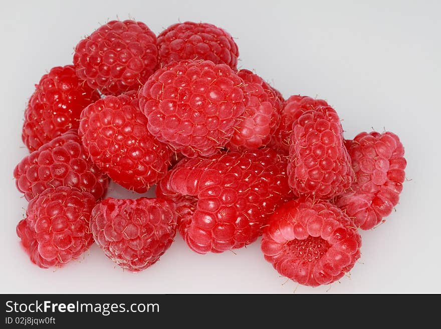 Clump of fresh, ripe raspberries isolated on a white background. Clump of fresh, ripe raspberries isolated on a white background