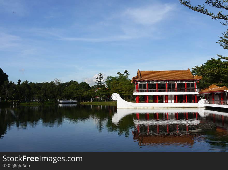 A beautiful stone boat with teahouse pavilion built above its deck sits on the lagoon at Chinese Garden