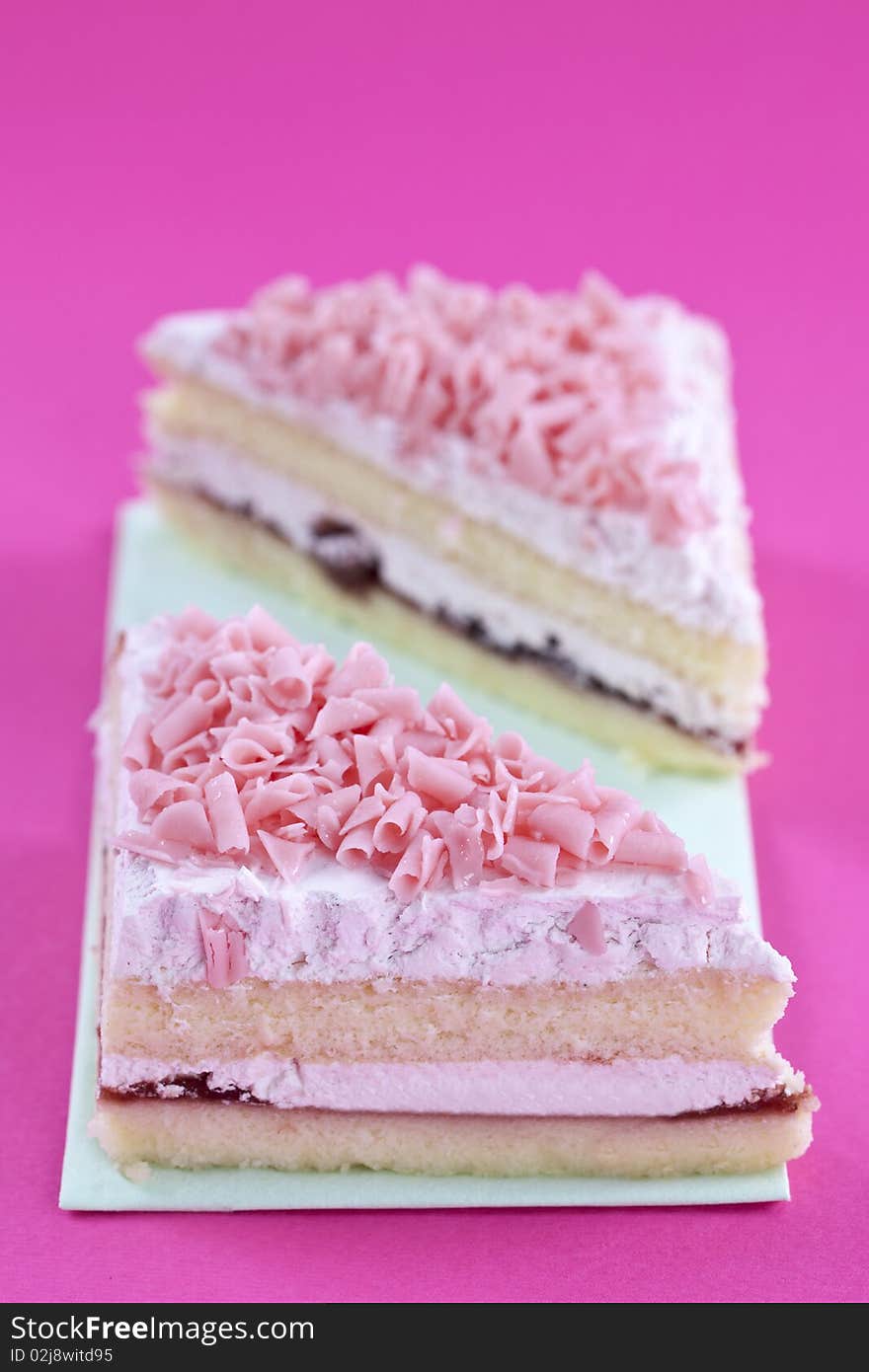 Freshly made cakes on pink background