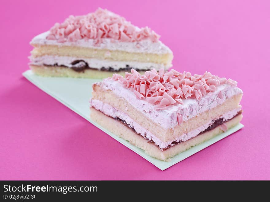 Freshly made cakes on pink background