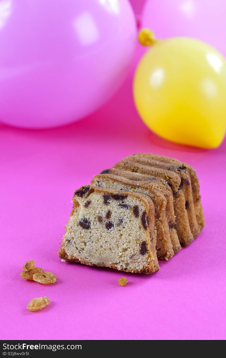 Overhead shot of freshly baked cake on pink table top