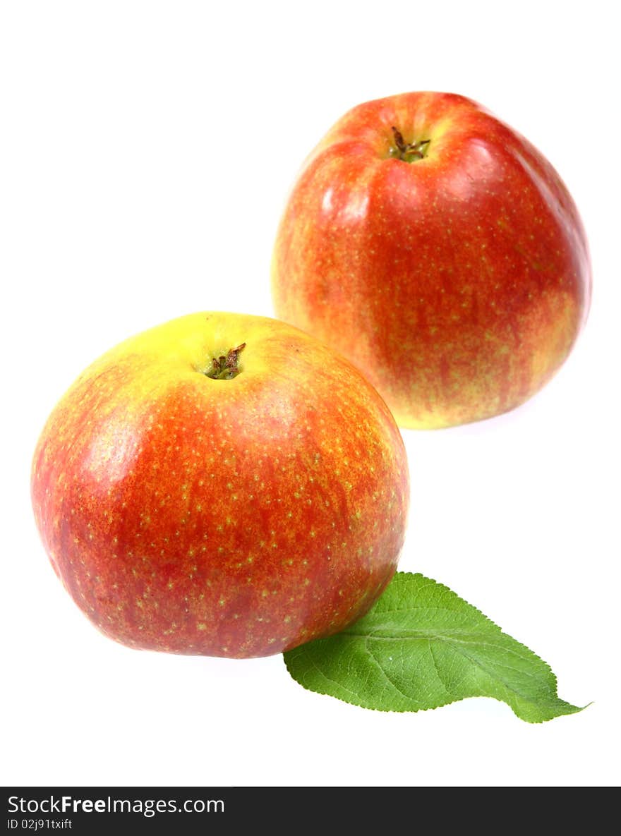 Ripe fresh red apples with leaf isolated on white