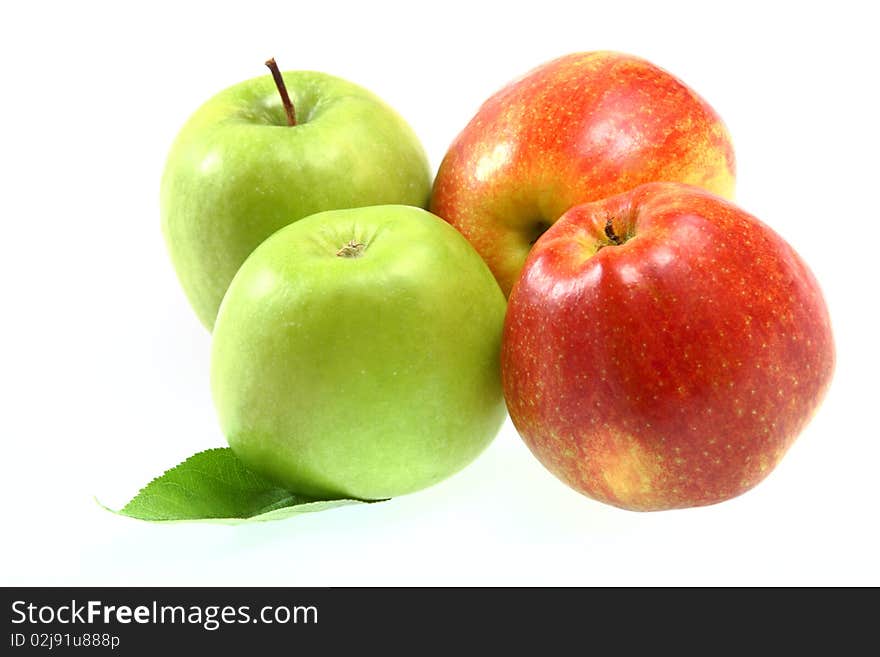 Ripe fresh red and green apples with leaf isolated on white