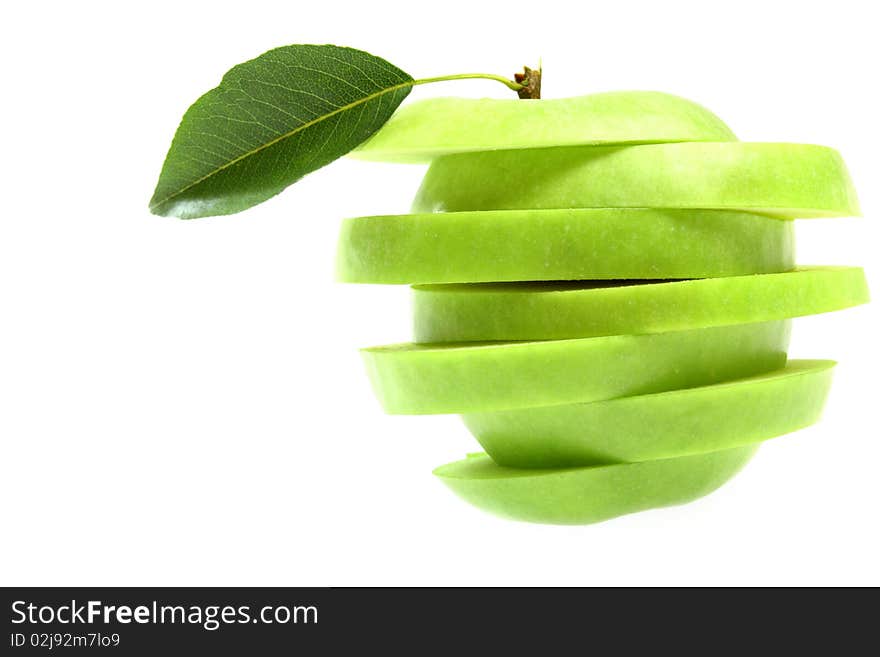 Ripe fresh green apple cut with leaf isolated on white