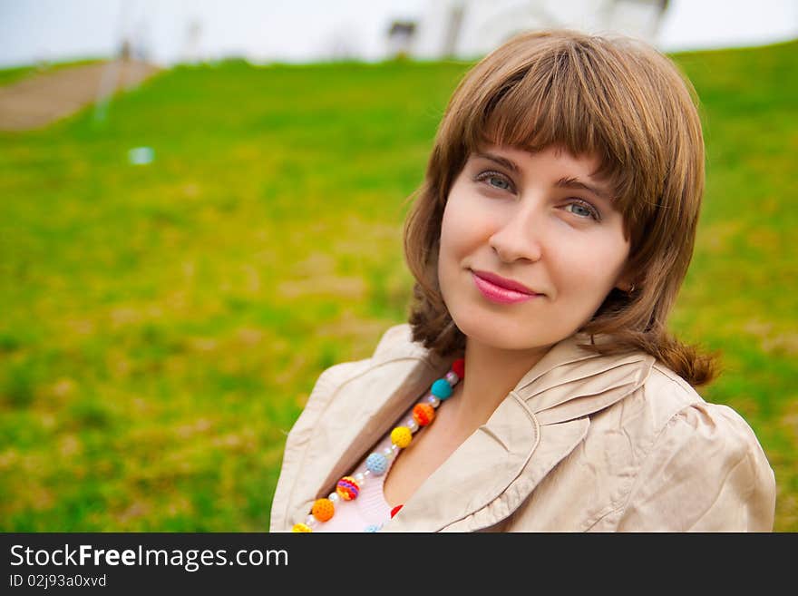 Woman's portrait with green grass on background. Woman's portrait with green grass on background