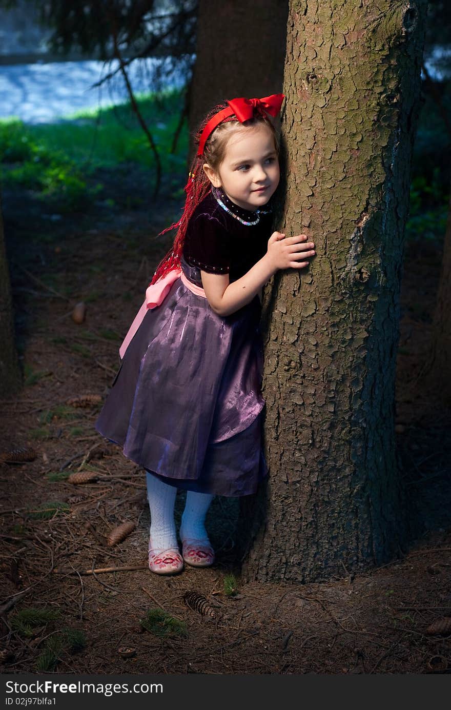 Snow white with apple, litle girl on a forest background