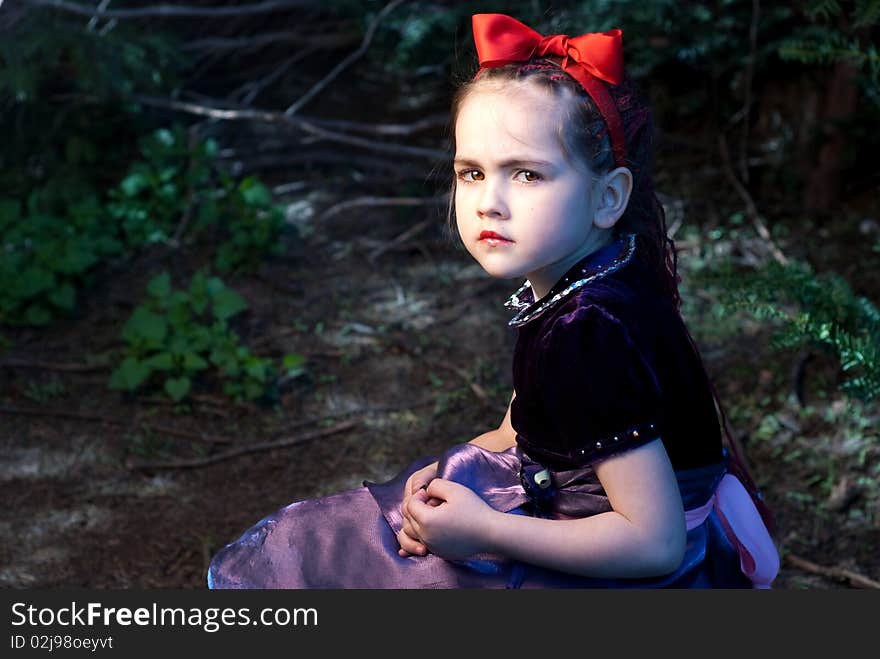 Snow white with apple, litle girl on a forest background