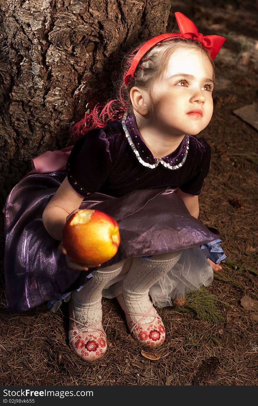 Snow white with apple, litle girl on a forest background