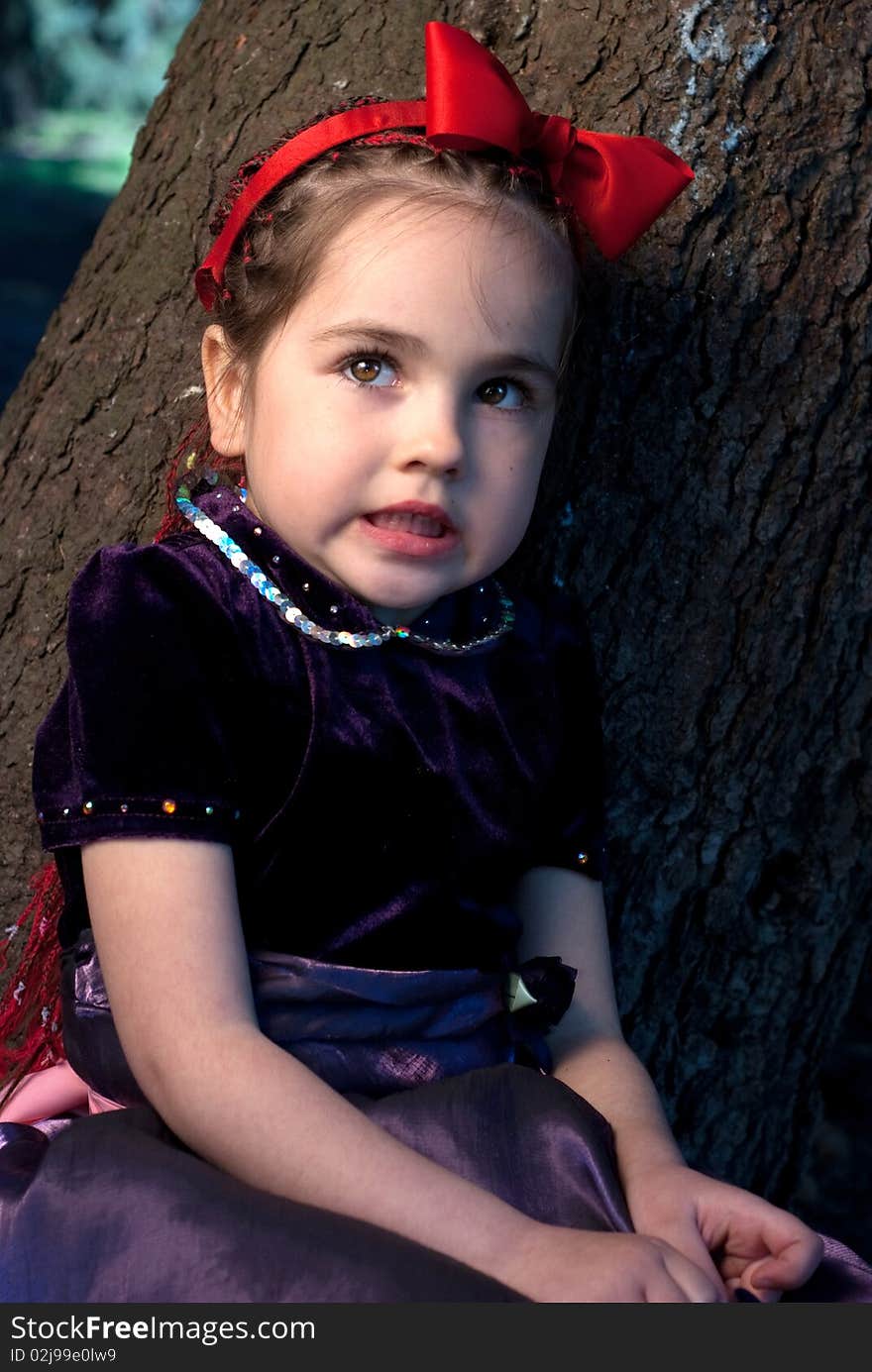 Snow white with apple, litle girl on a forest background