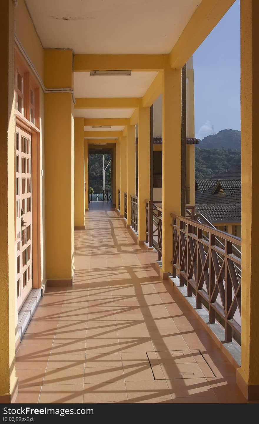 Perspective view of yellow painted building corridor with light and shadow. Perspective view of yellow painted building corridor with light and shadow