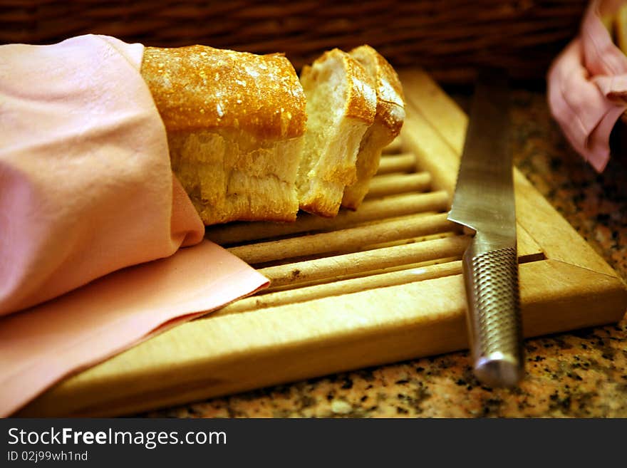 Slices of bread on chopping board with knife