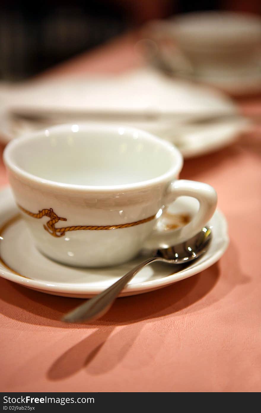 Coffee cup with small spoon on table