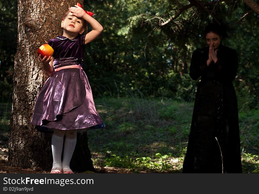 Stepmother gives poisoned apple give to snow white little girl. Stepmother gives poisoned apple give to snow white little girl