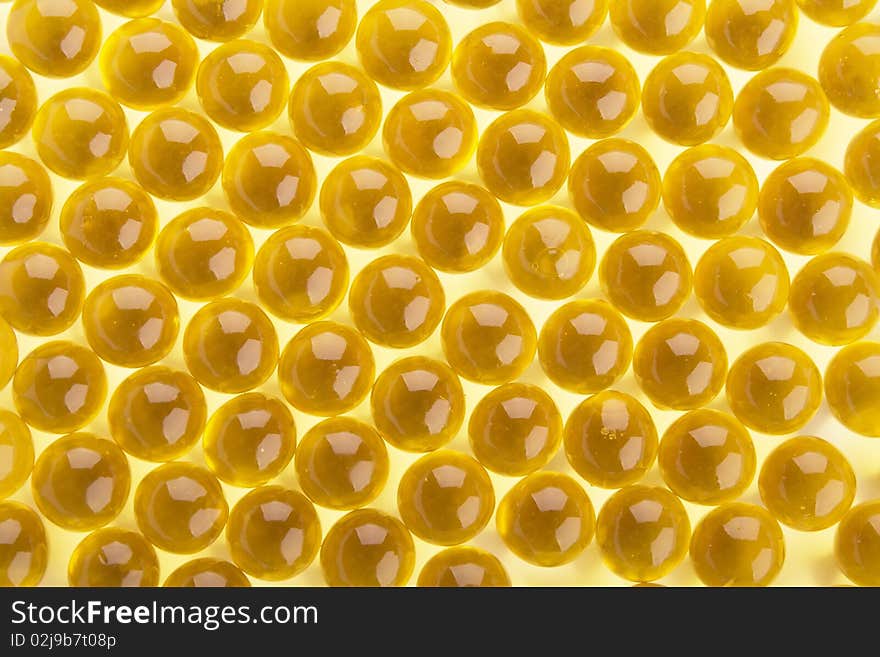 The abstract background from yellow  gel capsules. The abstract background from yellow  gel capsules