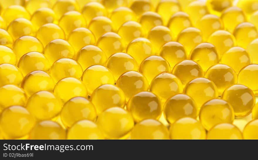 The abstract background from yellow  gel capsules. The abstract background from yellow  gel capsules