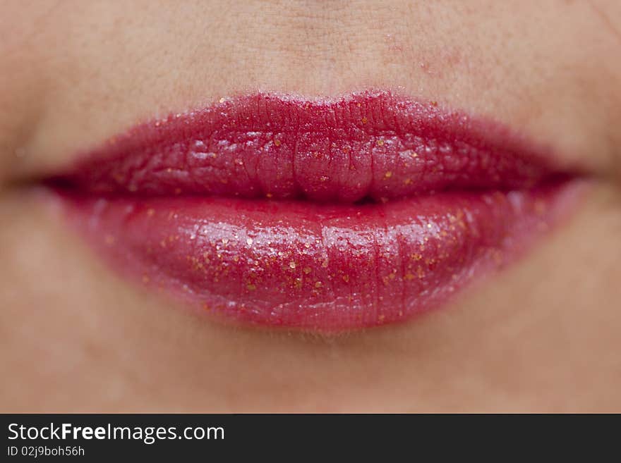 Close up view of some red lips smiling.