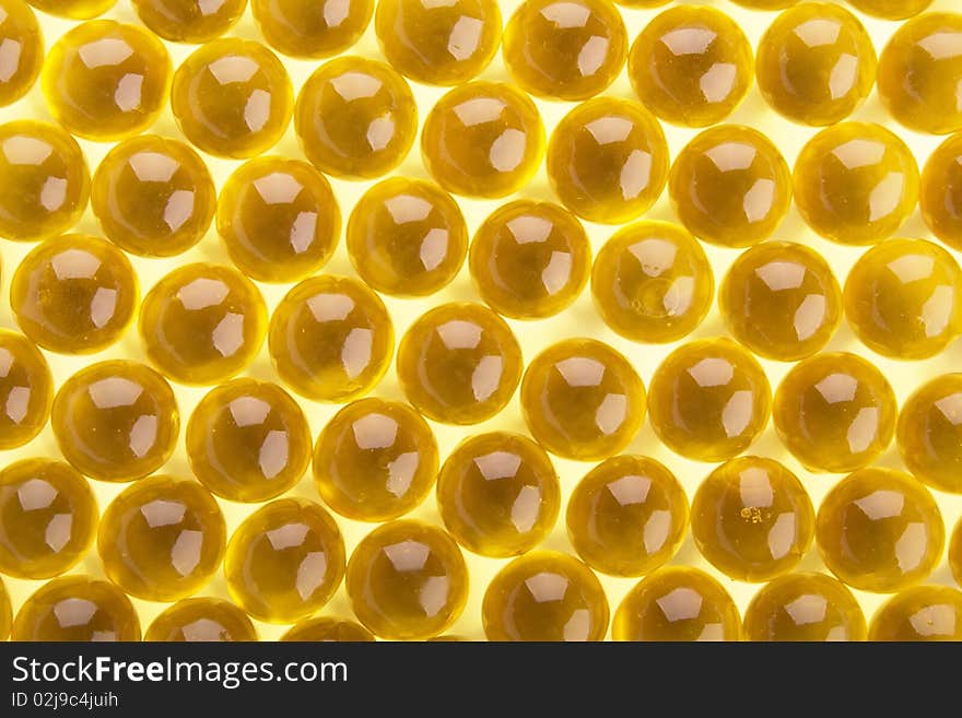 The abstract background from yellow  gel capsules. The abstract background from yellow  gel capsules