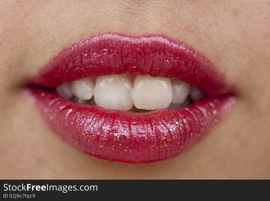 Close up view of some red lips smiling.