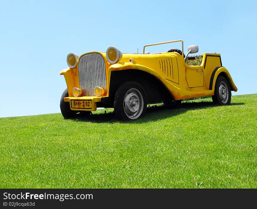 Decorative plaster car in park. Decorative plaster car in park