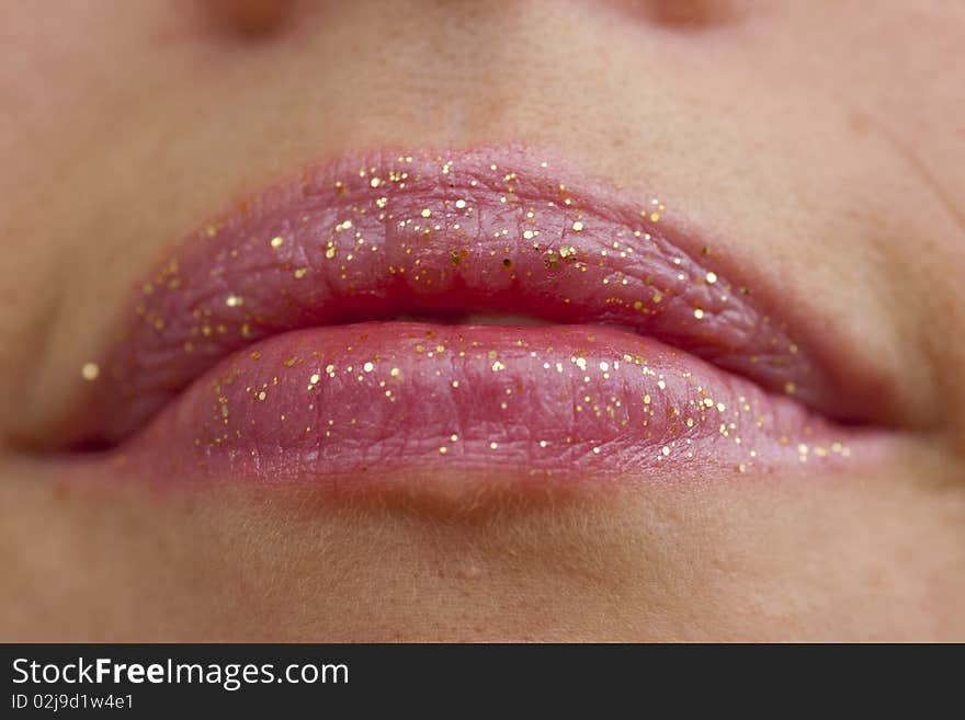 Close up view of some pink lips smiling.