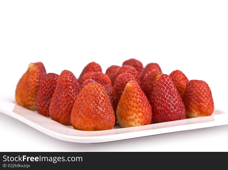 Strawberries on a plate isolated on white background