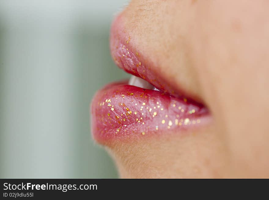 Close up view of some pink lips smiling.