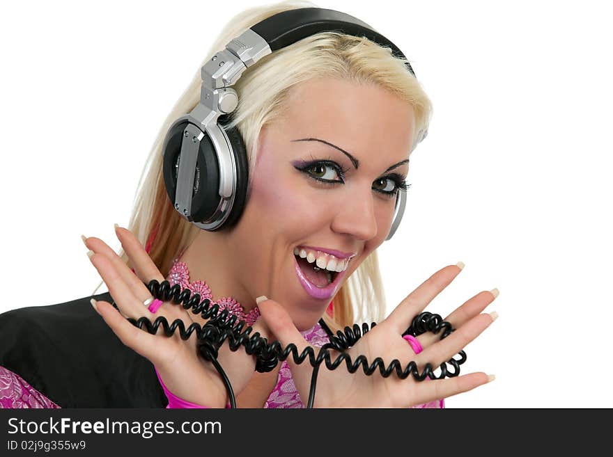 The beautiful smiling blonde dj in pink suit with a headphone