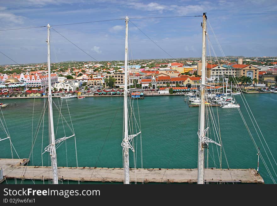 The harbor at Oranjestad, Aruba, seen through the masts of a yacht. The harbor at Oranjestad, Aruba, seen through the masts of a yacht