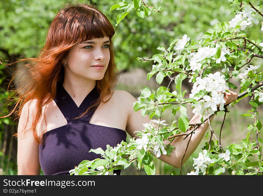 Young woman in blooming garden