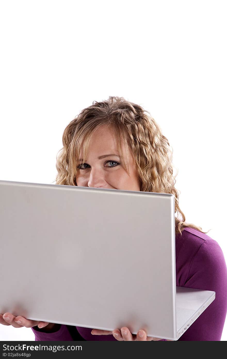 Woman in purple peeking over laptop