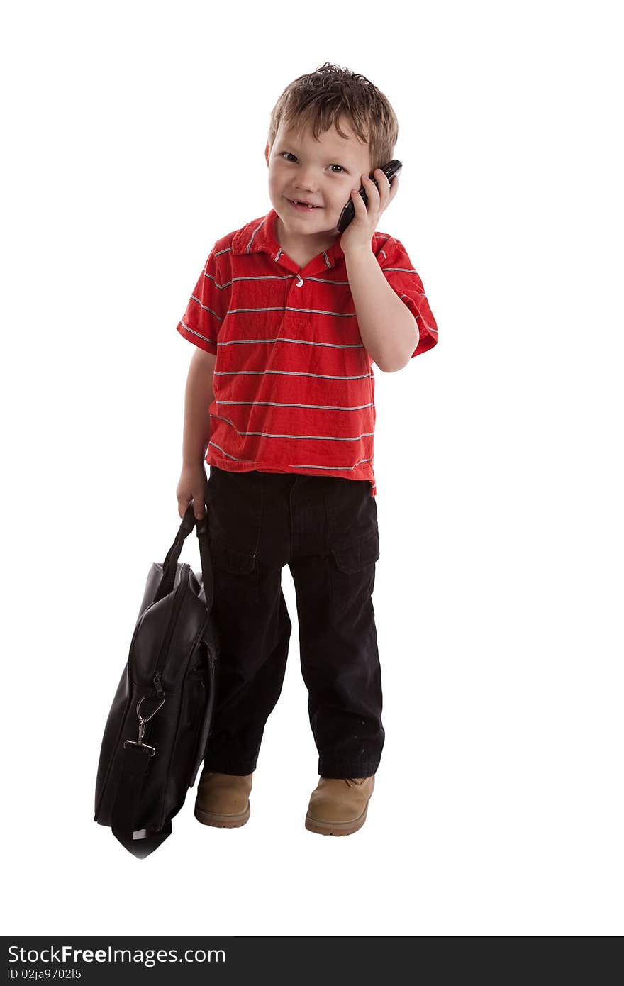 A young boy is smiling and talking on the phone. A young boy is smiling and talking on the phone