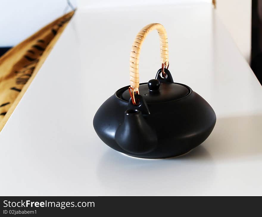 Black ceramic teapot on a tray. Black ceramic teapot on a tray