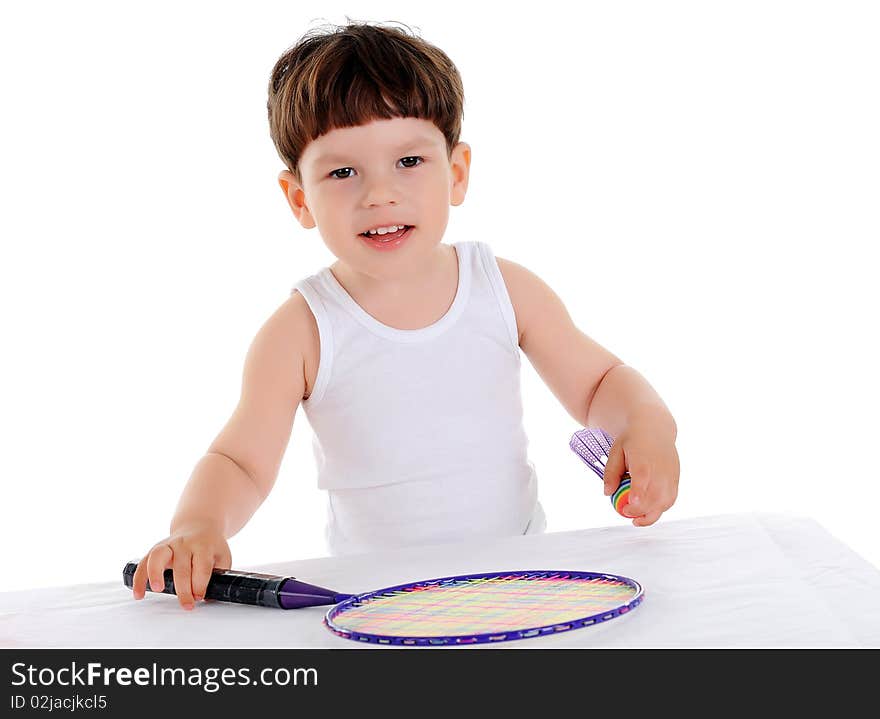 Little boy with a tennis racket on a white background. Little boy with a tennis racket on a white background