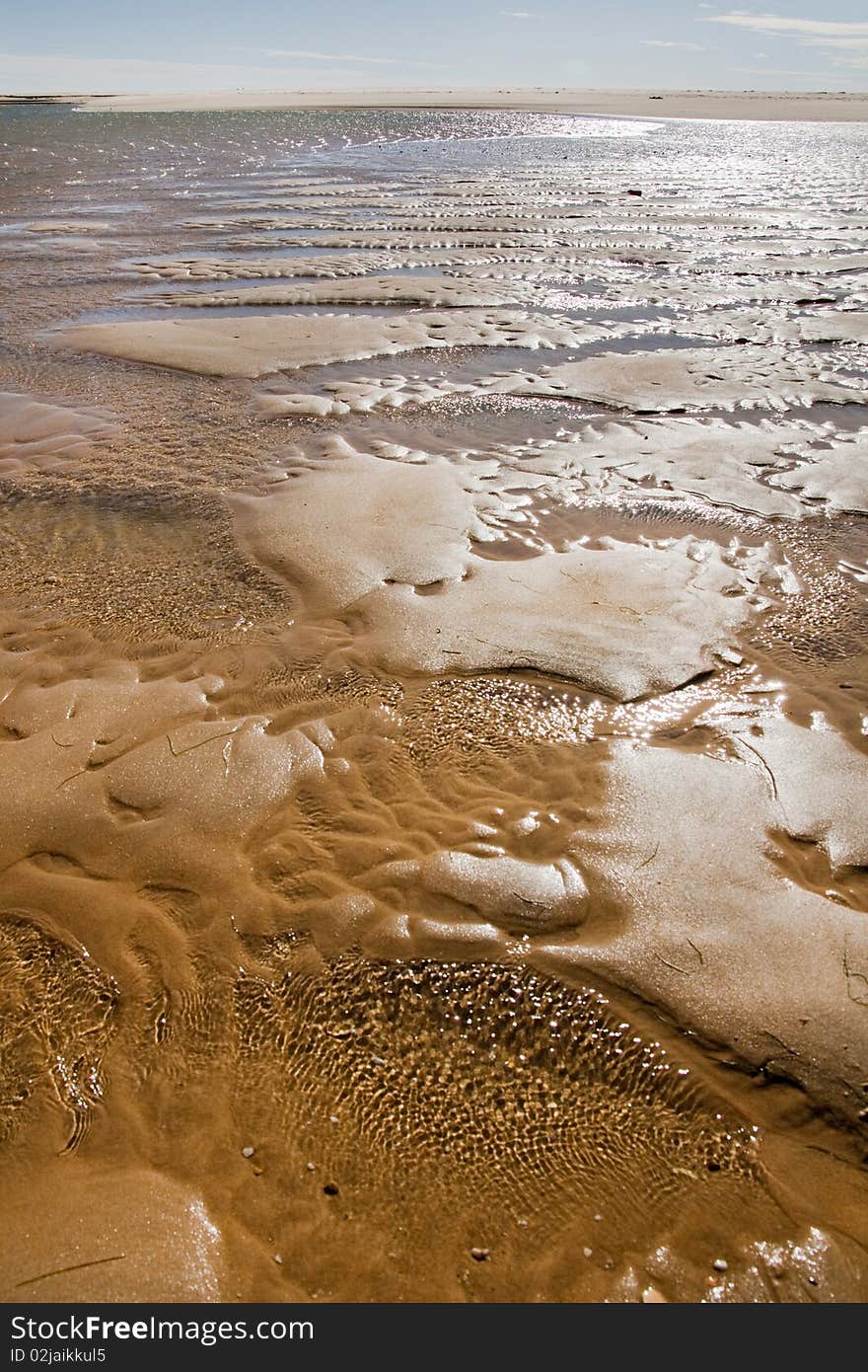 View of the shoreline of a beautiful beach on the Algarve, Portugal. View of the shoreline of a beautiful beach on the Algarve, Portugal.