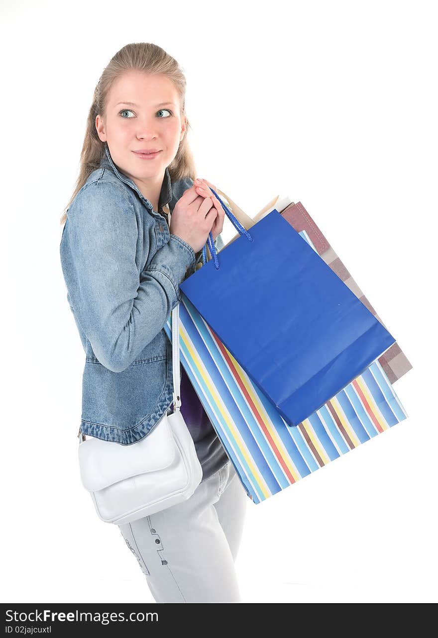 Young girl with purchases on white background