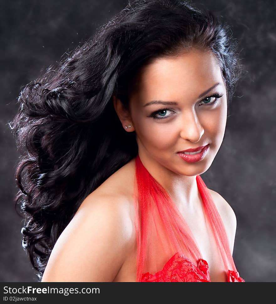 Beautiful glamorous woman with red dress, studio shot