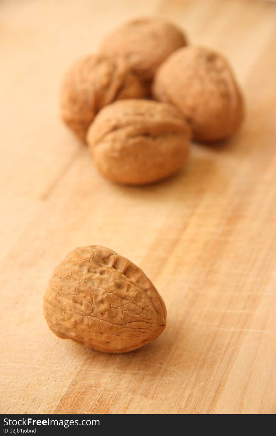 Walnuts close up isolated on brown wooden background