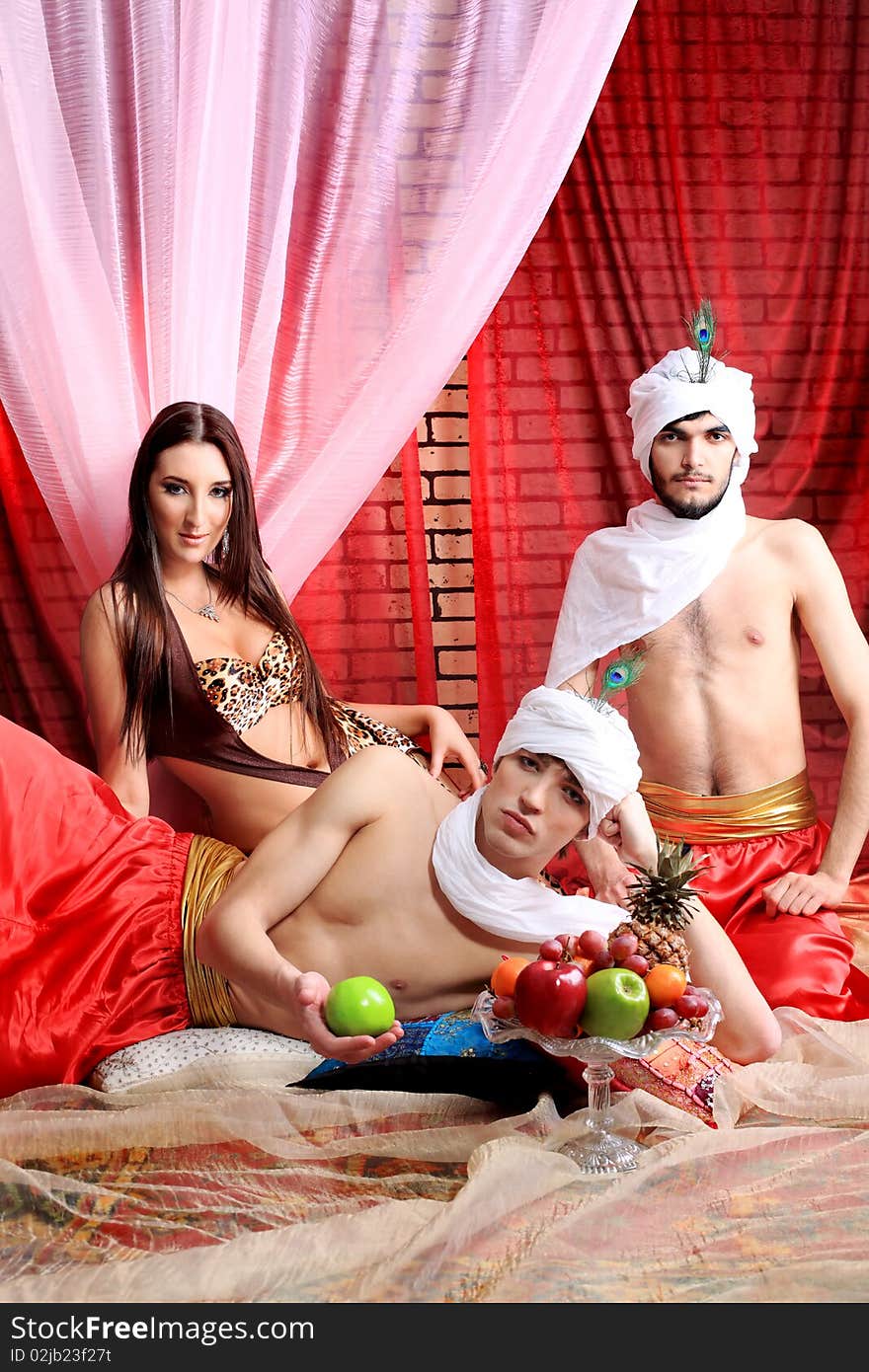 Shot of three young people in oriental costumes. Shot of three young people in oriental costumes.