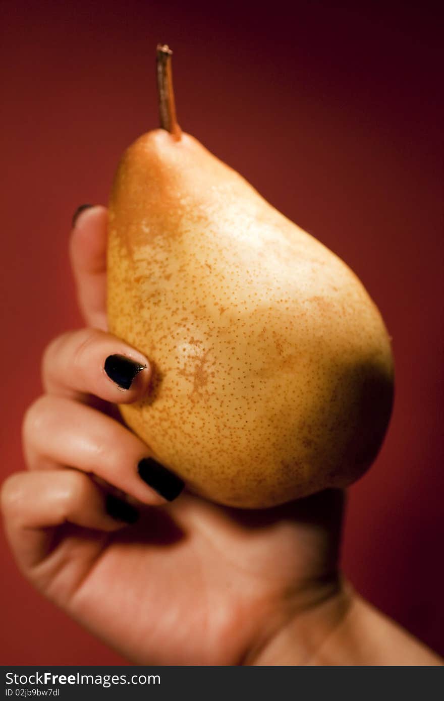 Hand holding pear