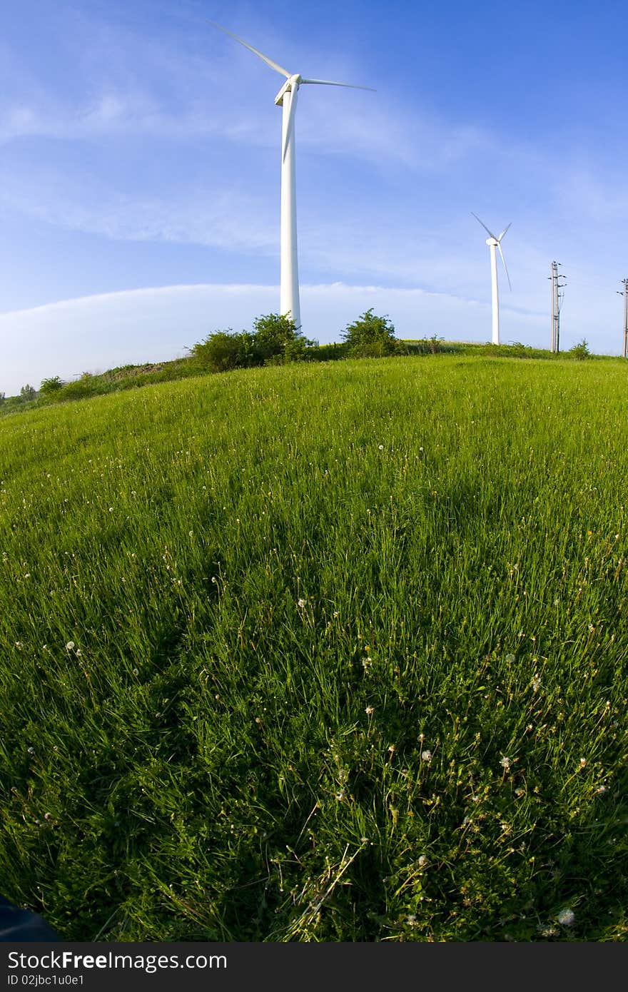 Wind turbine on the meadow shown by fisheye lens. Wind turbine on the meadow shown by fisheye lens