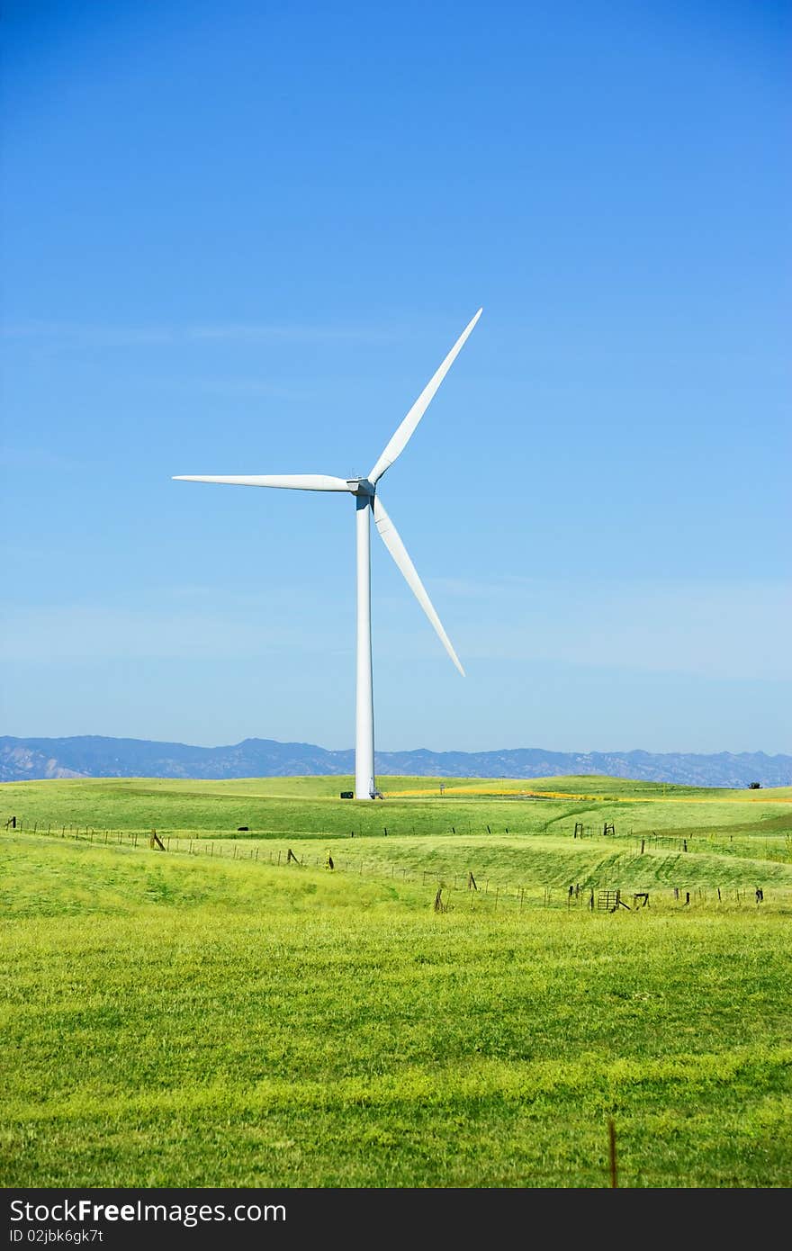 A turbine in a field at wind farm