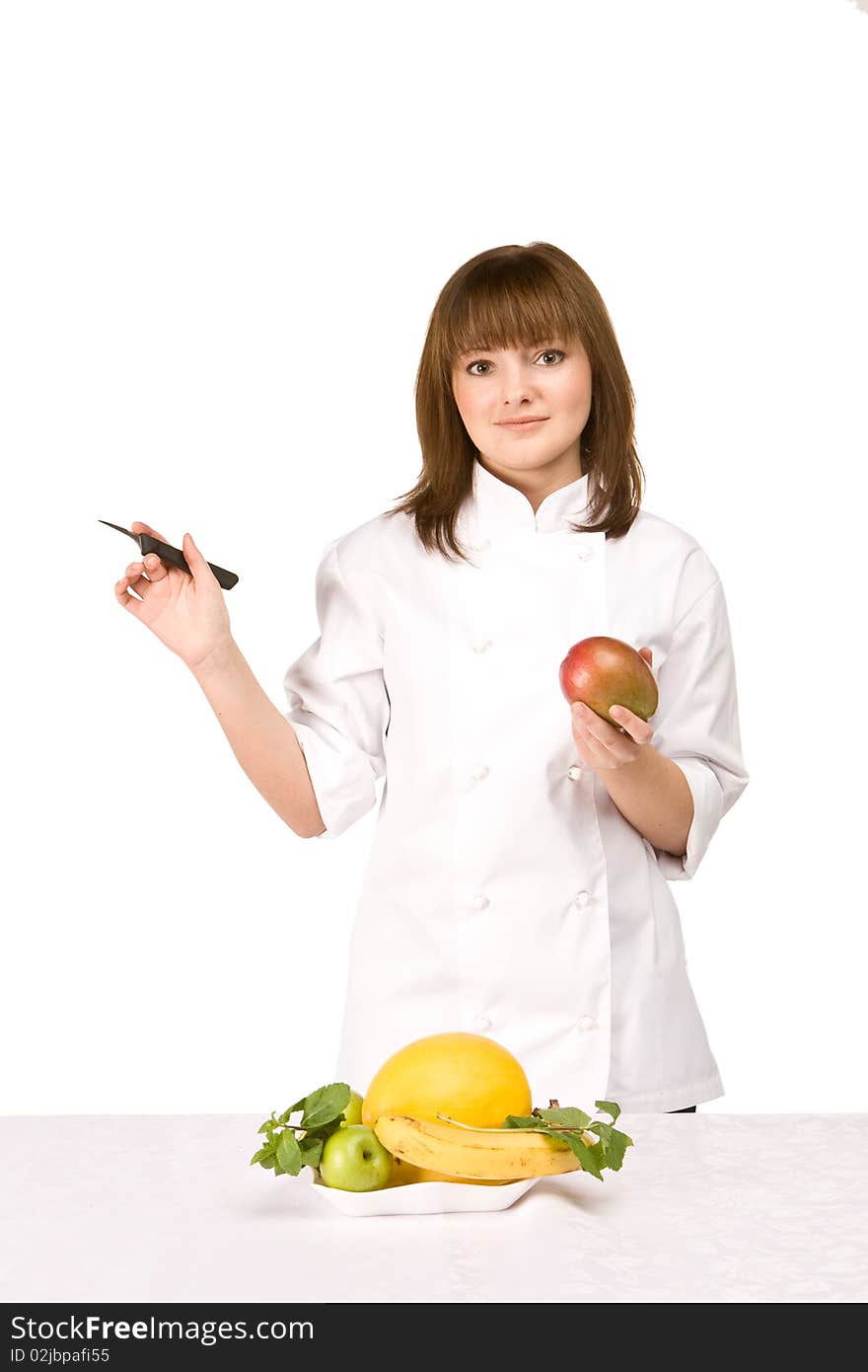 Cook girl holding a knife and a mango